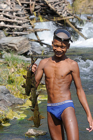 Boy with freshly caught fish along the Mekong River in northern Cambodia. 
© WWF-Cambodia / Gordon Congdon