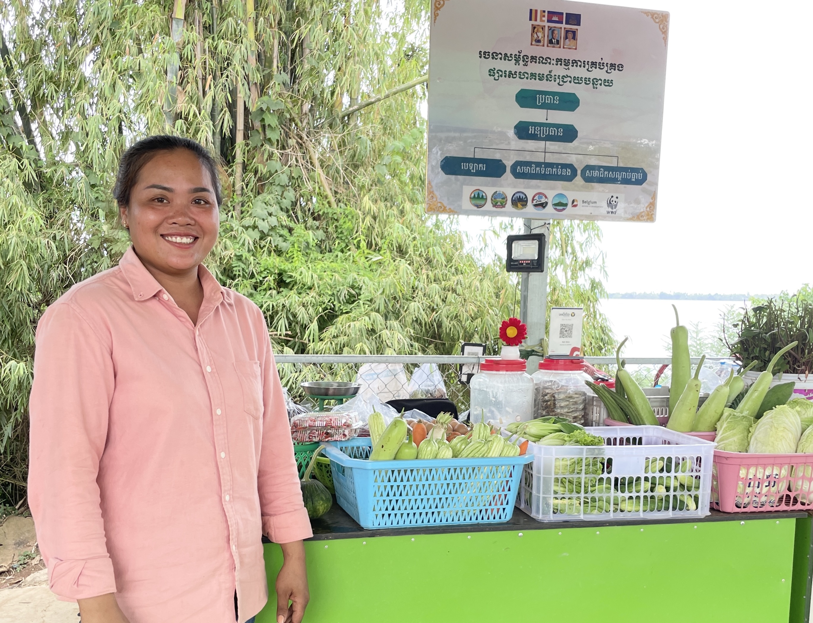 Mrs Sok Davy promoting her vegetable and fish products in her community's new market.